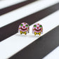 Matching Mr Blobby stud earrings featuring his pink face with yellow spots, big green eyes, a cheesy grin and a yellow polka dot bow tie.